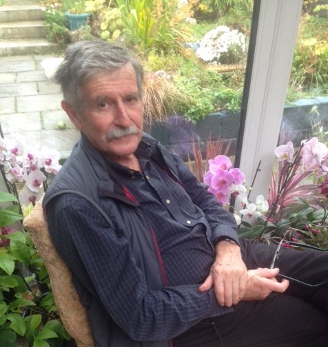 And with grey hair sitting on a chair and surrounded by flowers